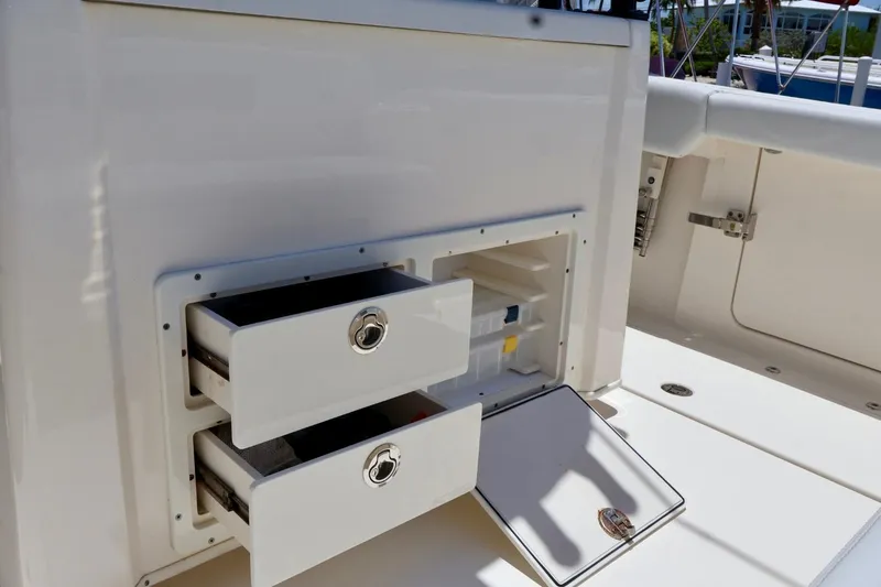 Slide: The Image of 2022 Cobia 301 Center Console boat storage drawers and compartments. - 19