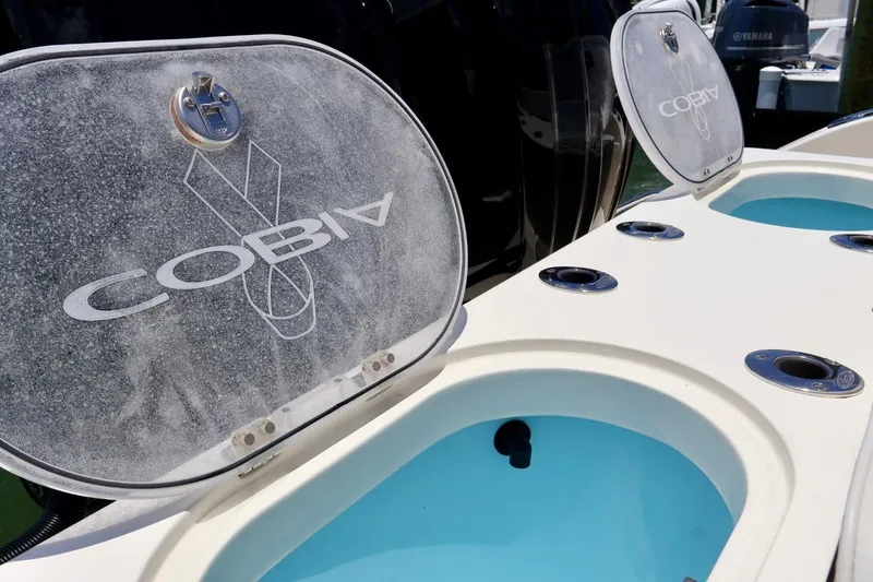 Slide: The Image of 2022 Cobia 301 Center Console boat with open storage compartments. - 21