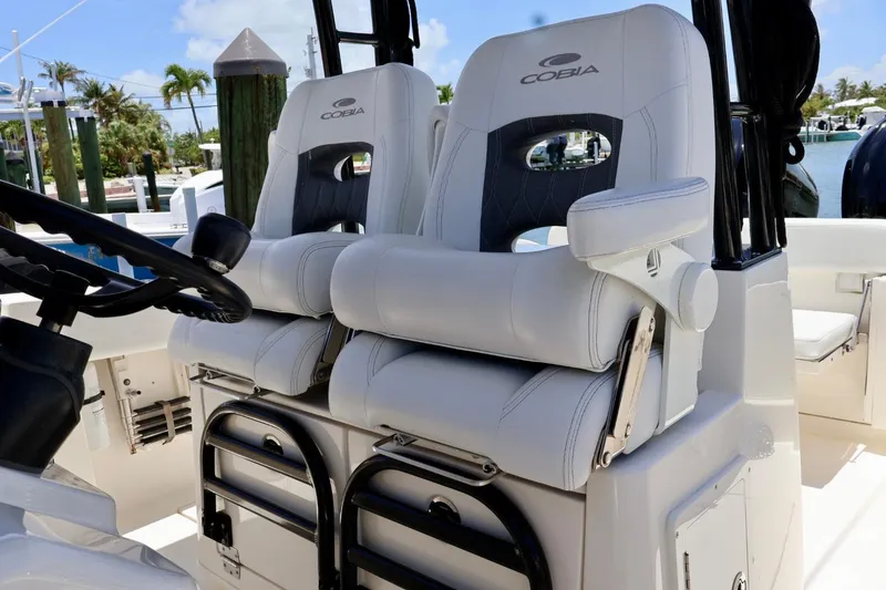 Slide: The Image of 2022 Cobia 301 Center Console boat seats, featuring luxurious white upholstery and ergonomic design. - 8