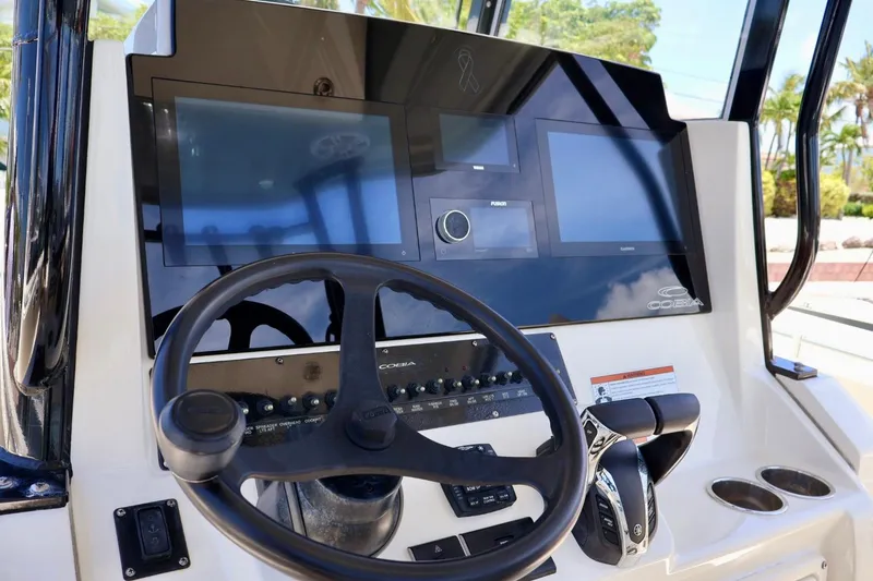 Slide: The Image of 2022 Cobia 301 Center Console helm with modern controls and dual displays. - 9