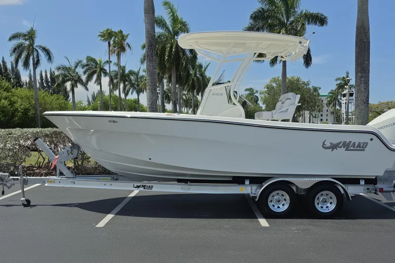 The Image of 2026 Mako 226 Center Console boat on trailer, parked with palm trees in the background. - 0