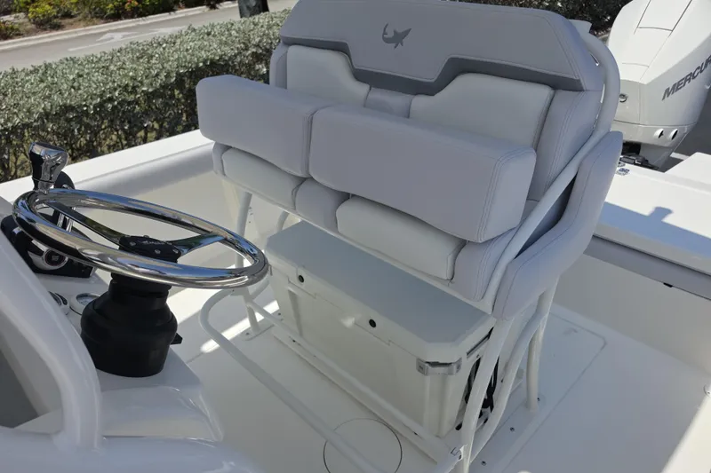 Slide: The Image of 2026 Mako 226 Center Console boat helm with cushioned seating and steering wheel. - 12