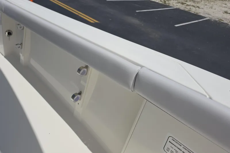 Slide: The Image of 2026 Mako 226 Center Console boat interior detail with white cushioned railing. - 15