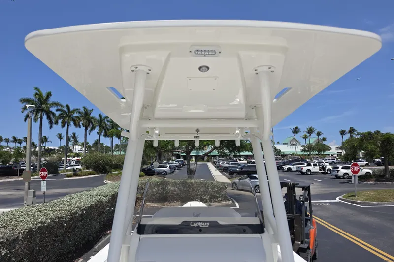 Slide: The Image of 2026 Mako 226 Center Console boat in a sunny parking lot with palm trees. - 16