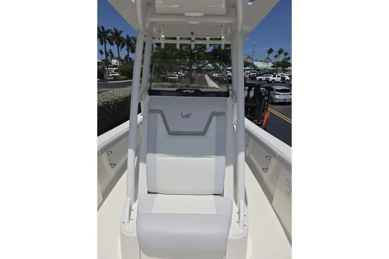 Slide: The Image of 2026 Mako 226 Center Console boat seat with sleek design and palm trees in background. - 18
