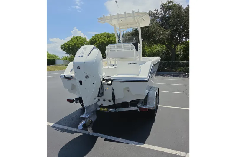 Slide: The Image of 2026 Mako 226 Center Console boat with V8 engine in a parking lot. - 22