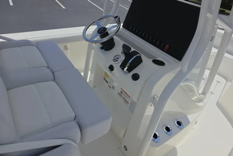 Slide: The Image of 2026 Mako 226 Center Console boat interior with steering wheel and controls. - 6