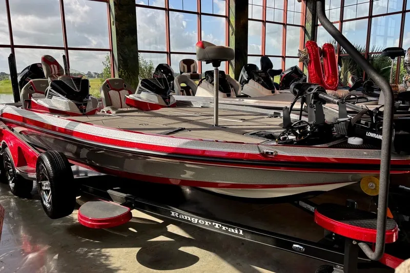 The Image of 2026 Ranger Z521R Cup-Equipped boat in showroom, featuring sleek red and gray design. - 0