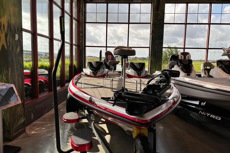 Slide: The Image of 2026 Ranger Z521R Cup-Equipped boat displayed in a showroom with large windows. - 1