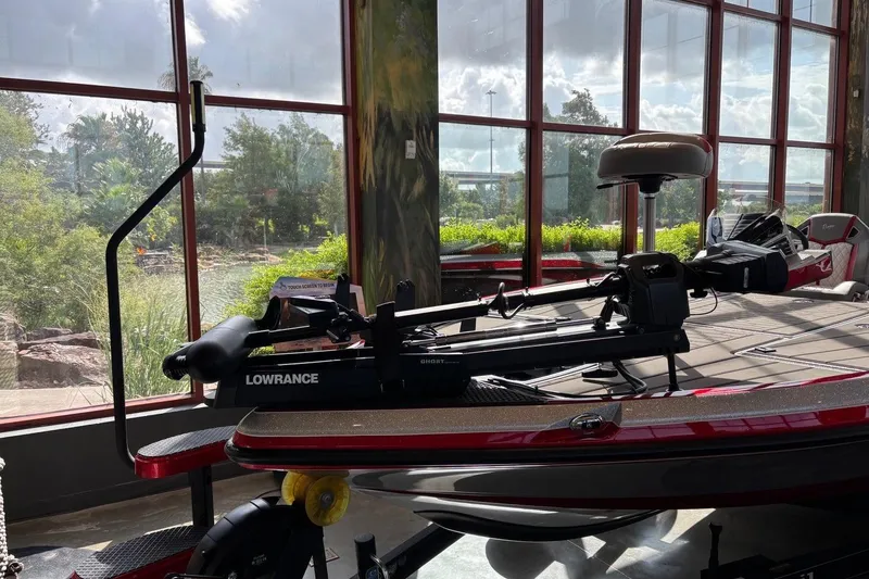 Slide: The Image of 2026 Ranger Z521R Cup-Equipped boat with Lowrance equipment, displayed indoors near large windows. - 2