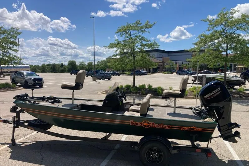 Slide: The Image of 2026 Tracker Bass Tracker Classic Limited boat in parking lot under blue sky. - 3