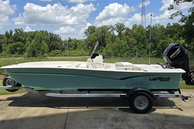 Slide: The Image of 2026 Mako Pro Skiff 17 CC boat on trailer, parked outdoors. - 4