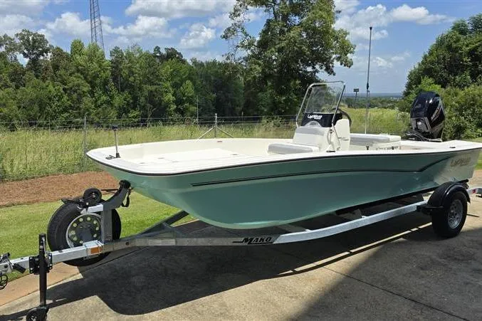 Slide: The Image of 2026 Mako Pro Skiff 17 CC boat on trailer, parked outdoors on a sunny day. - 3
