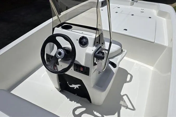 Slide: The Image of 2026 Mako Pro Skiff 17 CC boat interior with steering console and seating. - 10