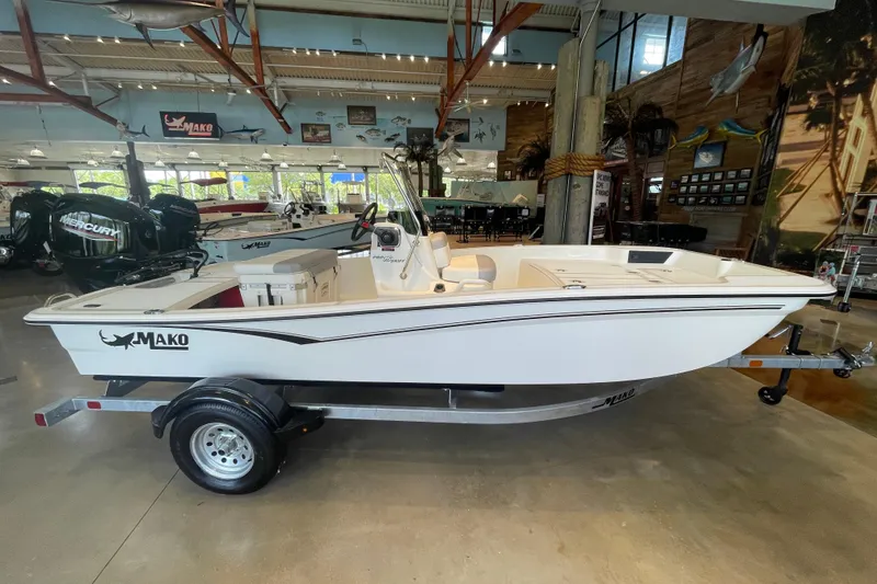 The Image of 2026 Mako Pro Skiff 15 CC boat displayed in a showroom with marine decor. - 0