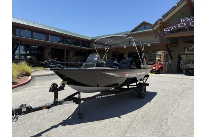 Slide: The Image of 2026 Tracker Pro Guide V-16 SC boat on trailer outside service center. - 3