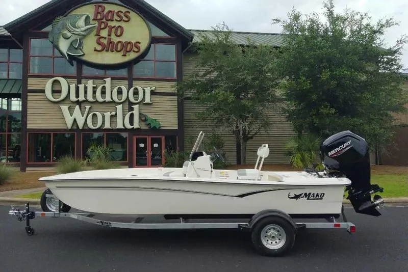 Slide: The Image of 2026 Mako Pro Skiff 17 CC boat on trailer outside Bass Pro Shops Outdoor World. - 0