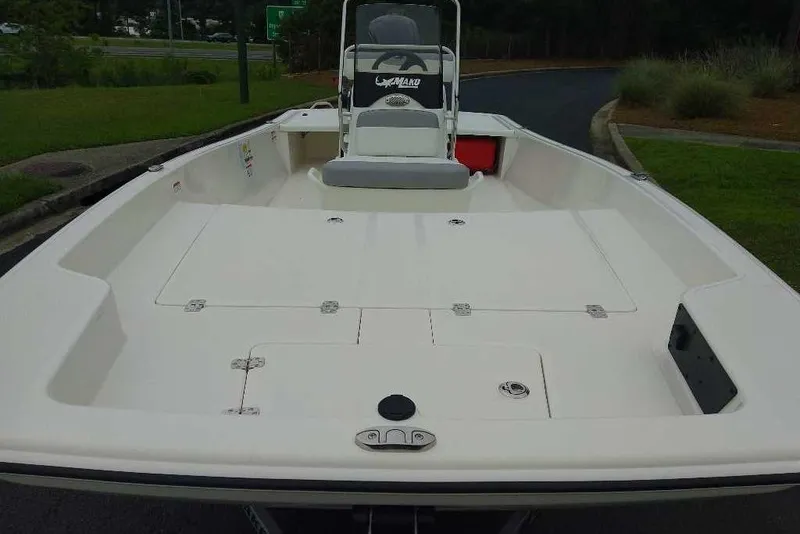 Slide: The Image of 2026 Mako Pro Skiff 17 CC boat, spacious deck, white finish, outdoor setting. - 1