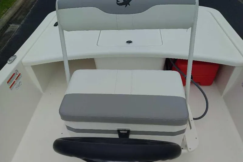 Slide: The Image of 2026 Mako Pro Skiff 17 CC boat interior with seating and storage compartments. - 2