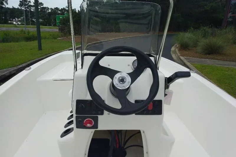 Slide: The Image of 2026 Mako Pro Skiff 17 CC boat console with steering wheel and controls. - 3