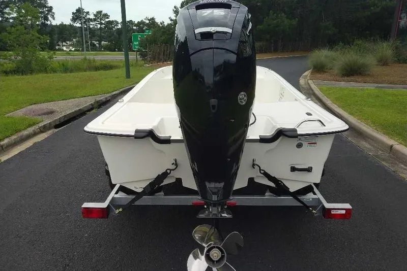 Slide: The Image of 2026 Mako Pro Skiff 17 CC boat on trailer, featuring a powerful outboard motor. - 4