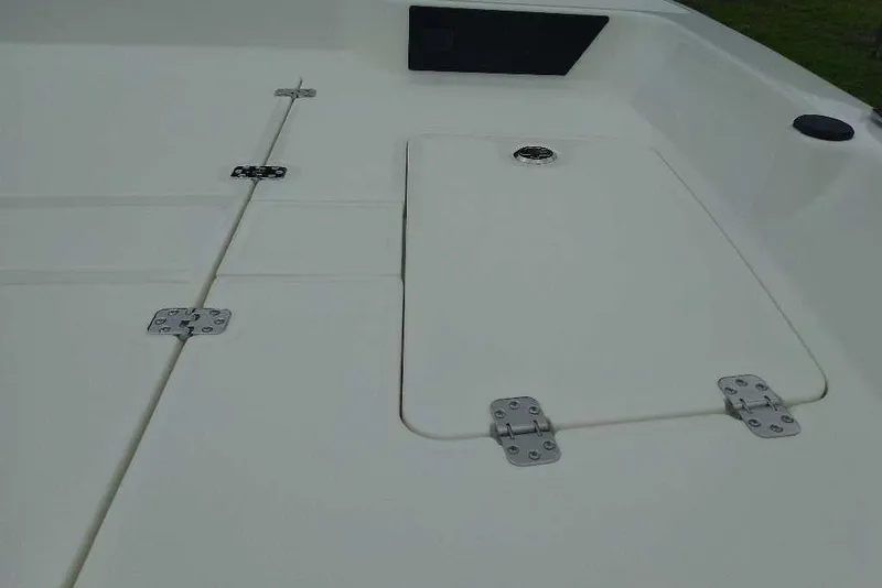 Slide: The Image of 2026 Mako Pro Skiff 17 CC deck with storage hatch and hinges. - 7