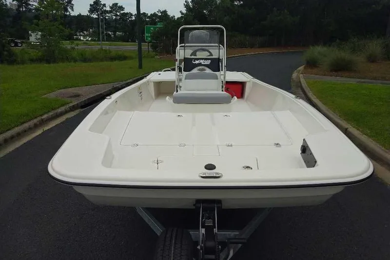 Slide: The Image of 2026 Mako Pro Skiff 17 CC boat on trailer, parked on a road. - 8