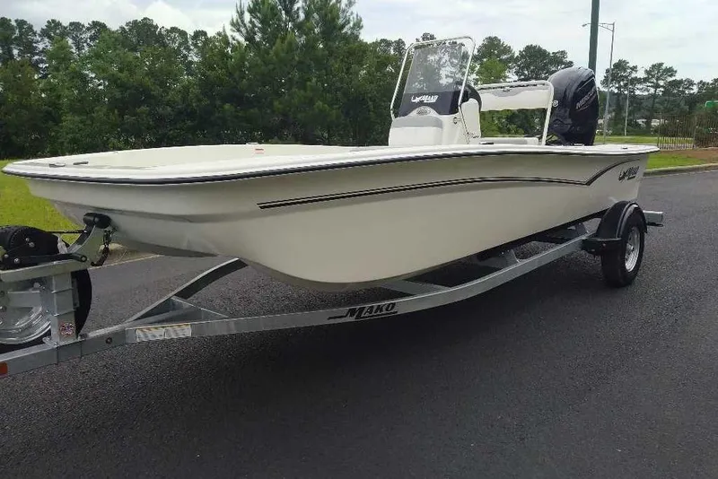 Slide: The Image of 2026 Mako Pro Skiff 17 CC boat on trailer, parked on asphalt road. - 9