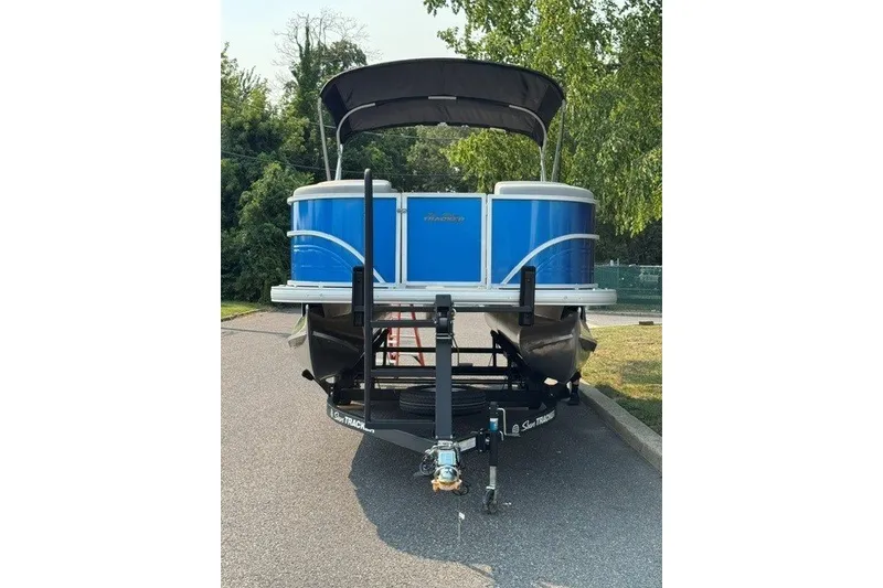 Slide: The Image of 2026 Sun Tracker Party Barge 20 DLX pontoon boat on trailer, parked outdoors. - 5