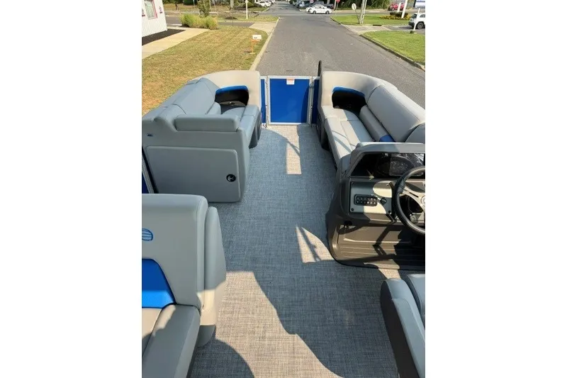 Slide: The Image of 2026 Sun Tracker Party Barge 20 DLX interior with gray seating and steering console. - 11