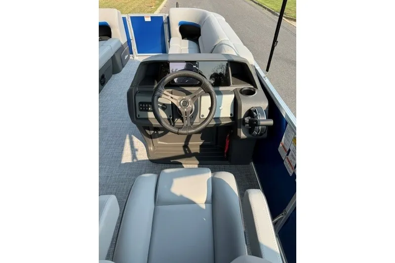 Slide: The Image of 2026 Sun Tracker Party Barge 20 DLX interior with steering wheel and seating. - 12