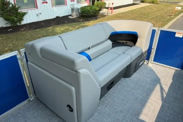 Slide: The Image of 2026 Sun Tracker Party Barge 20 DLX with comfortable gray seating and blue accents. - 9