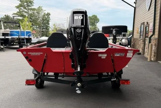 Slide: The Image of 2026 Tracker Pro Team 175 boat, red exterior, parked outdoors, rear view with motor. - 3