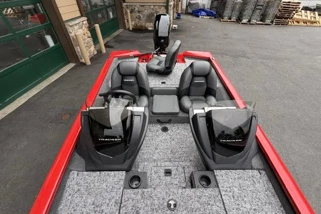 Slide: The Image of 2026 Tracker Pro Team 175 boat with dual seats and modern dashboard, parked outdoors. - 5