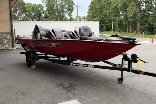 Slide: The Image of 2026 Tracker Pro Team 175 boat in red, parked on a trailer outdoors. - 2