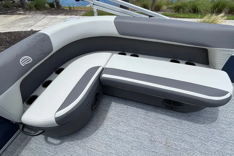 Slide: The Image of 2026 Sun Tracker Bass Buggy 16 XL Select boat seating with cup holders and gray upholstery. - 19