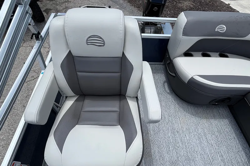 Slide: The Image of 2026 Sun Tracker Bass Buggy 16 XL Select boat seats, featuring gray and white upholstery. - 18