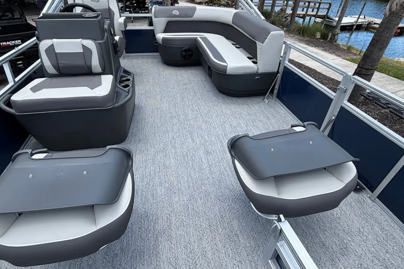 Slide: The Image of 2026 Sun Tracker Bass Buggy 16 XL Select pontoon boat interior with gray seating and carpet. - 13