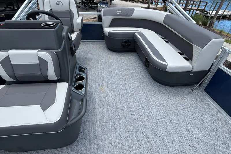 Slide: The Image of 2026 Sun Tracker Bass Buggy 16 XL Select interior with gray seating and cup holders. - 14