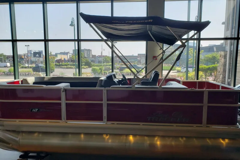 Slide: The Image of 2026 Sun Tracker Party Barge 18 DLX pontoon boat displayed indoors. - 2
