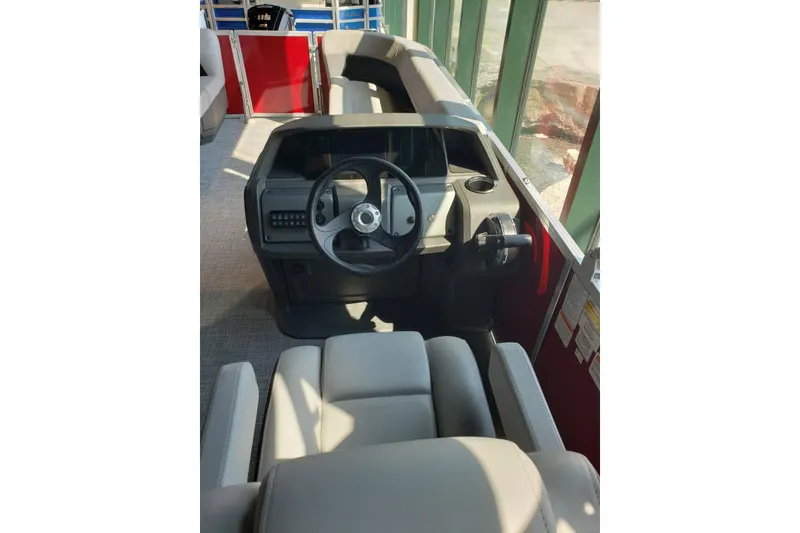 Slide: The Image of 2026 Sun Tracker Party Barge 18 DLX interior with steering wheel and seating. - 4