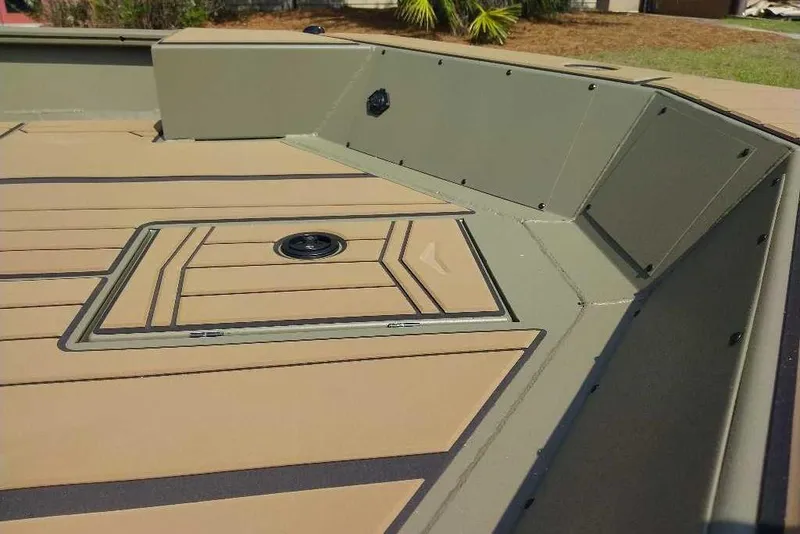 Slide: The Image of 2026 Tracker Grizzly 1756 T Marsh boat deck with tan and green finish. - 10