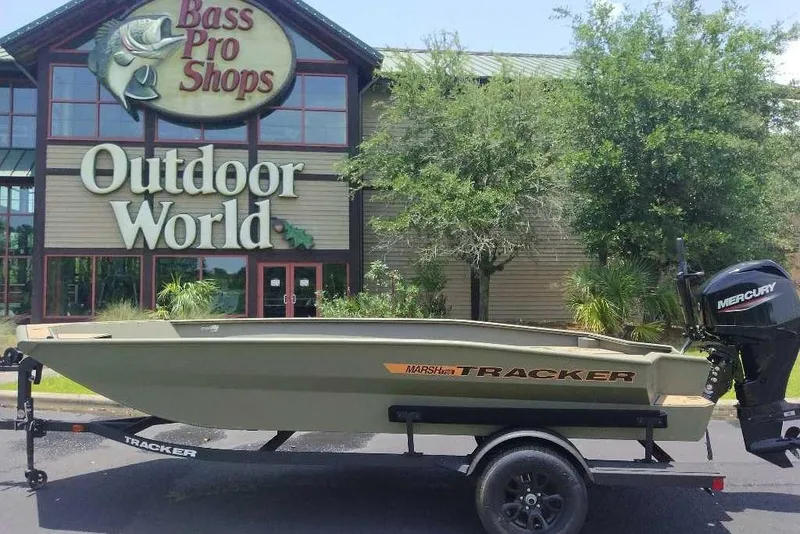 Slide: The Image of 2026 Tracker Grizzly 1756 T Marsh boat outside Bass Pro Shops Outdoor World. - 13