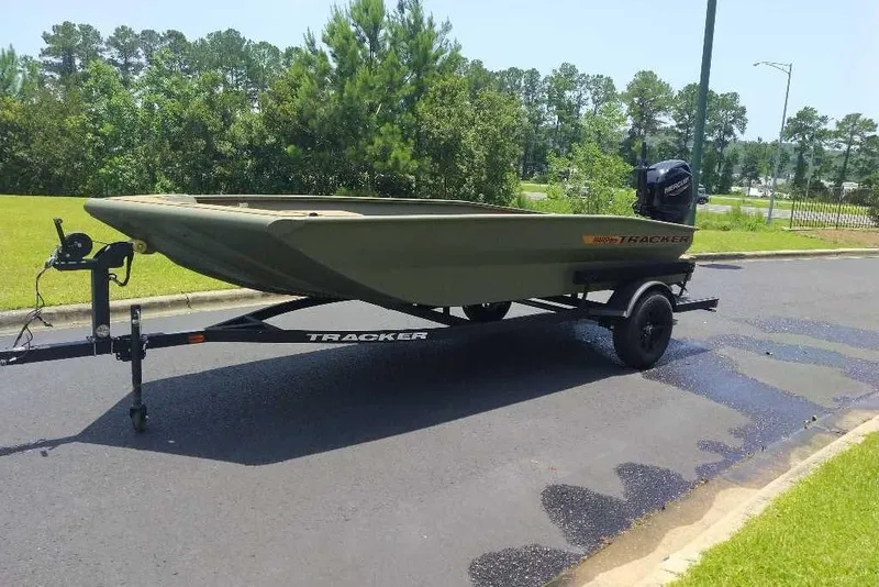 Slide: The Image of 2026 Tracker Grizzly 1756 T Marsh boat on trailer, parked on a road. - 3