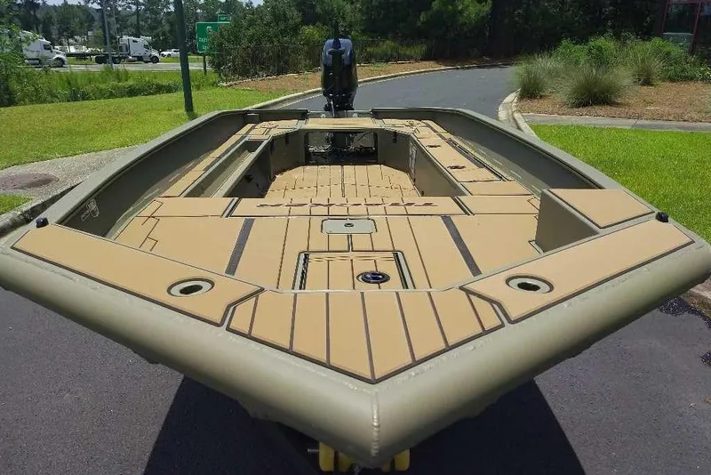 Slide: The Image of 2026 Tracker Grizzly 1756 T Marsh boat with spacious deck, parked outdoors. - 4