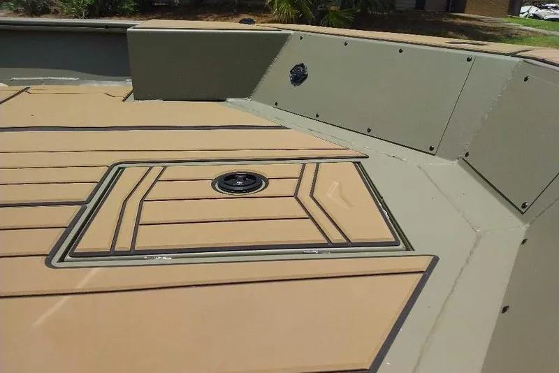 Slide: The Image of 2026 Tracker Grizzly 1756 T Marsh boat deck with tan and green design. - 5