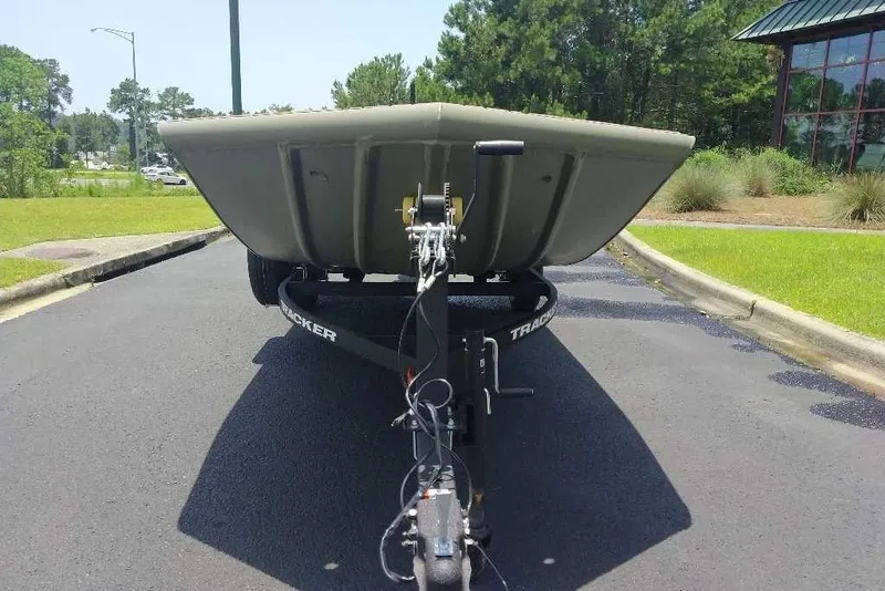 Slide: The Image of 2026 Tracker Grizzly 1756 T Marsh boat on trailer, parked on asphalt road. - 6