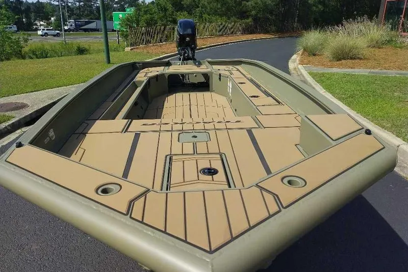Slide: The Image of 2026 Tracker Grizzly 1756 T Marsh boat with spacious deck, parked outdoors. - 9