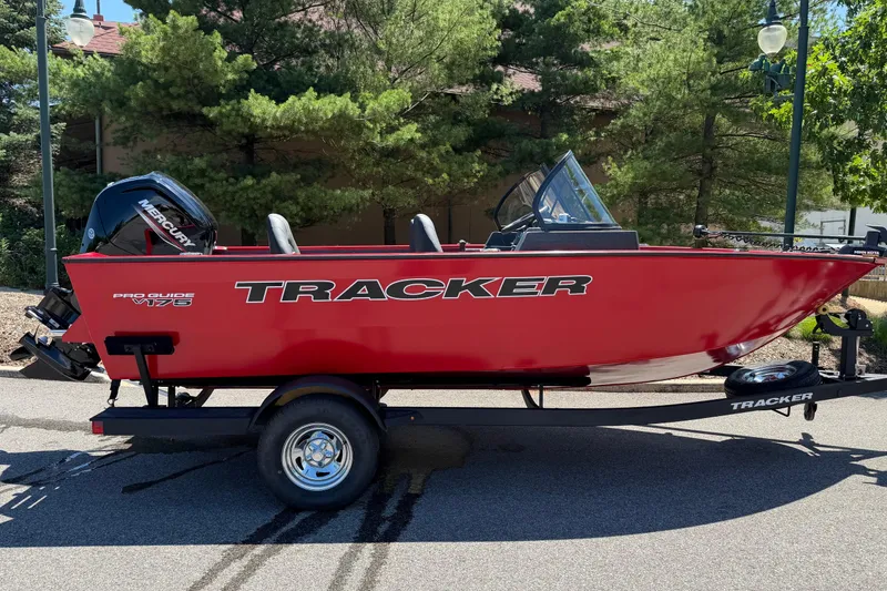The Image of 2026 Tracker Pro Guide V-175 WT boat in vibrant red on a trailer, parked outdoors. - 0