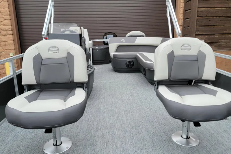 Slide: The Image of 2026 Sun Tracker Bass Buggy 18 DLX pontoon boat interior with gray seating. - 2